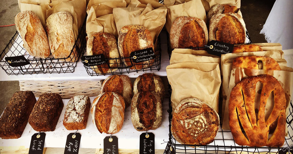 A mix of fresh breads at a weekend market stand